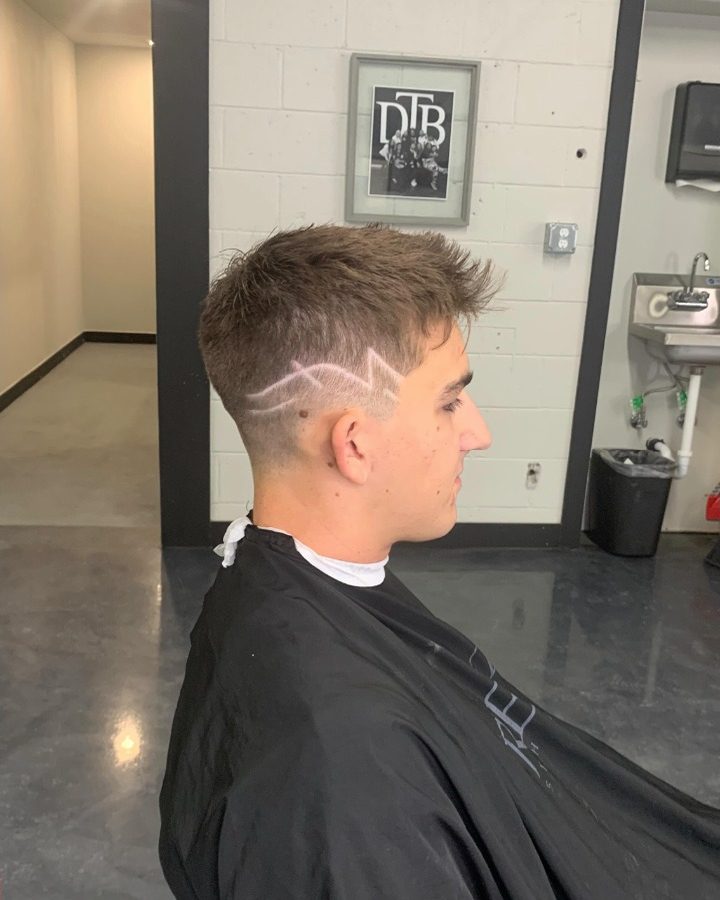 Fresh fade with a freestyle design, cut by Elijah Beck